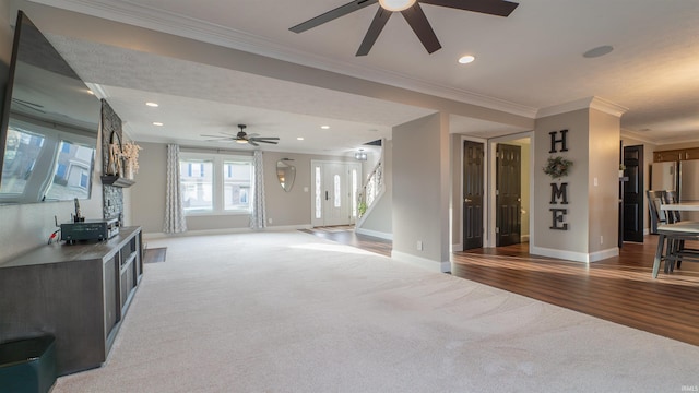 living area featuring recessed lighting, baseboards, light colored carpet, and stairs