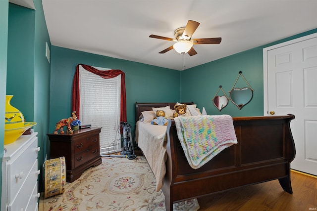 bedroom featuring a ceiling fan and wood finished floors