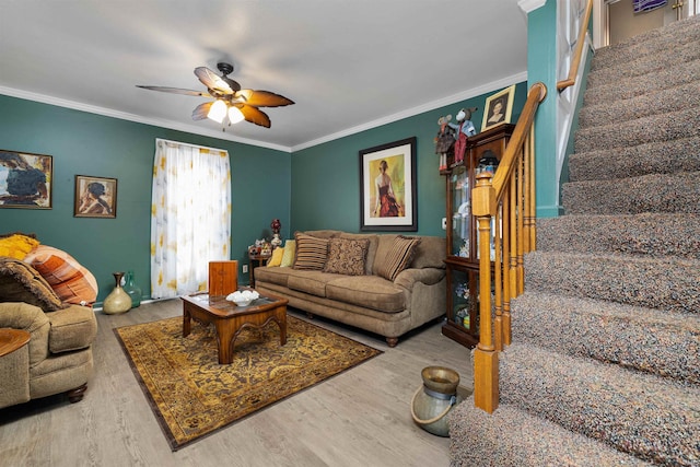 living room featuring ornamental molding, stairs, ceiling fan, and wood finished floors