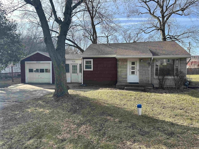 view of front facade with driveway, stone siding, roof with shingles, an attached garage, and a front yard