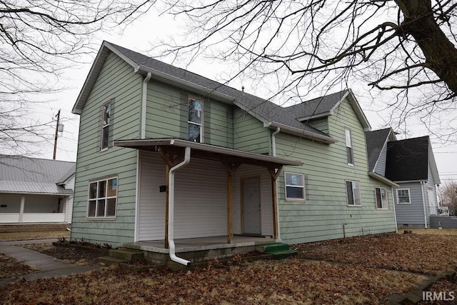 view of front of property featuring a porch and roof with shingles