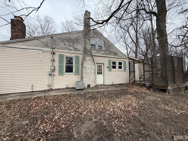 back of property featuring a deck and a chimney