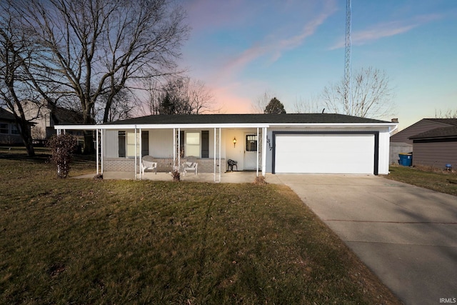 ranch-style house featuring a front lawn, driveway, covered porch, a garage, and brick siding