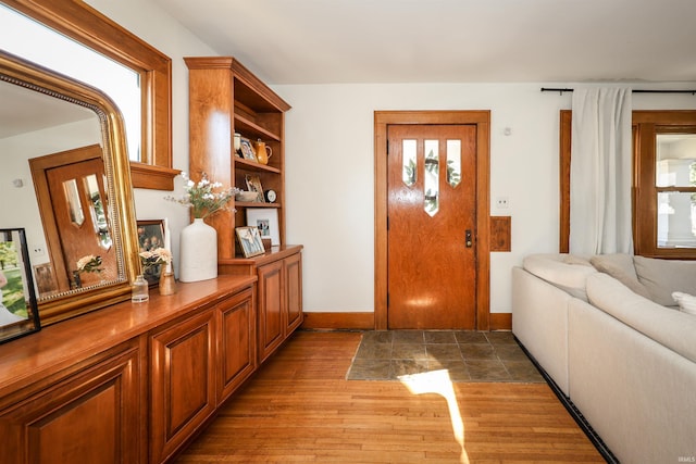 entryway with light wood-style flooring and baseboards