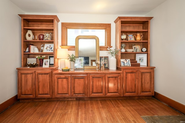 interior space featuring dark wood finished floors and baseboards