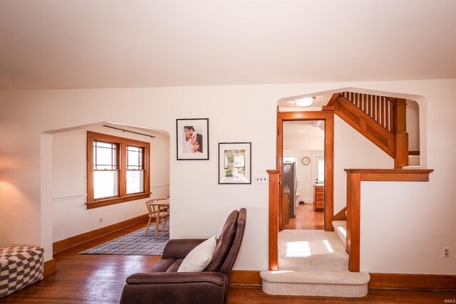 interior space featuring stairway, wood finished floors, and baseboards