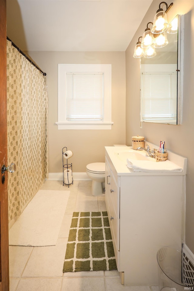 bathroom featuring toilet, curtained shower, tile patterned flooring, baseboards, and vanity