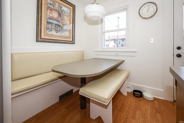 dining room with breakfast area and wood finished floors