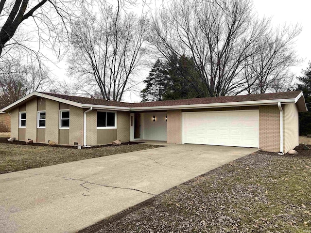 single story home with brick siding, concrete driveway, and an attached garage