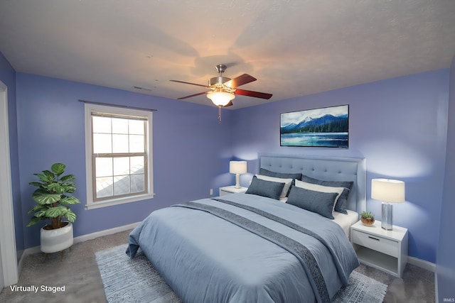 carpeted bedroom featuring baseboards and ceiling fan