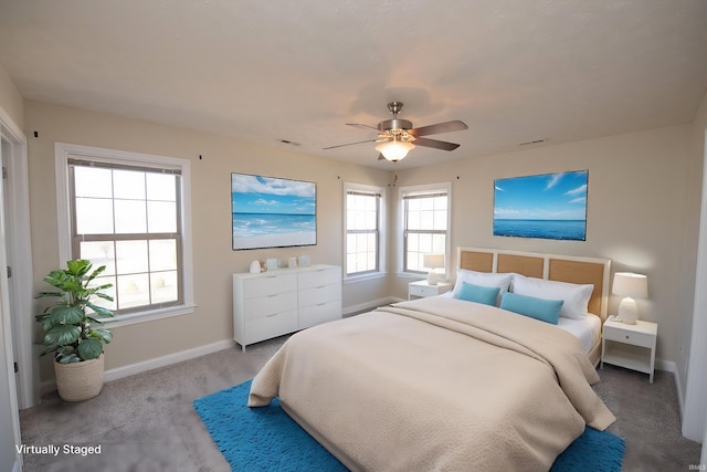 carpeted bedroom with visible vents, ceiling fan, and baseboards