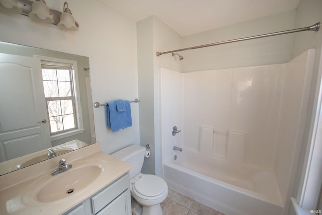 bathroom with tile patterned floors, toilet, vanity, and bathtub / shower combination