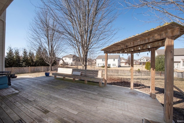 deck with a residential view and a fenced backyard