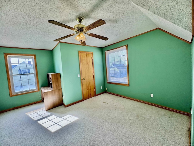 unfurnished bedroom with a textured ceiling, carpet flooring, and ornamental molding