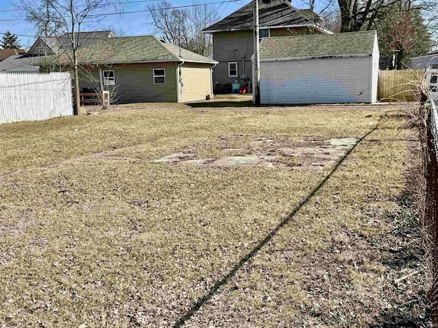 exterior space with an outdoor structure, fence, and a shed