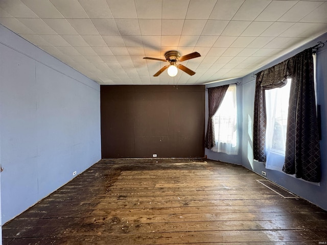 spare room with a ceiling fan and hardwood / wood-style flooring