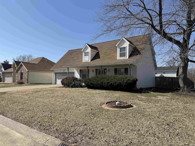 new england style home with concrete driveway, fence, and a garage