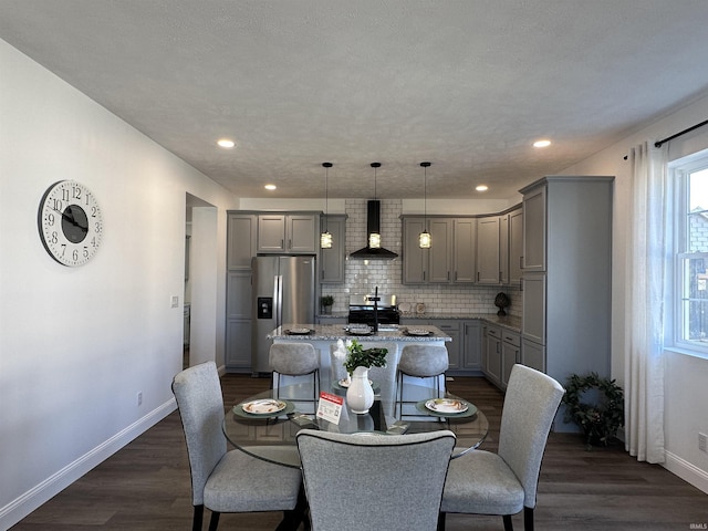 dining room with recessed lighting, baseboards, and dark wood finished floors