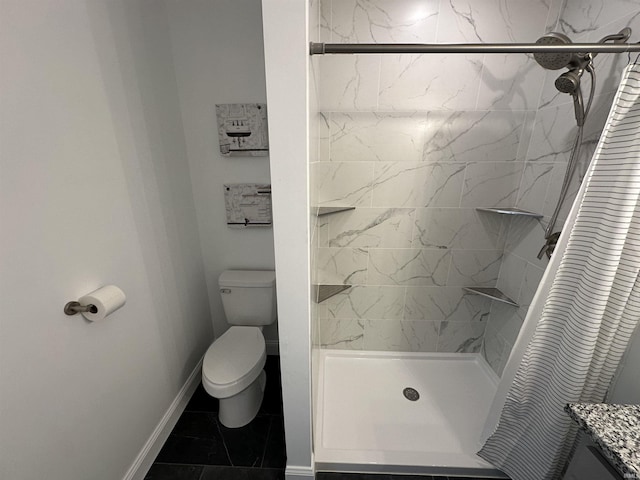 full bath featuring baseboards, toilet, a stall shower, and vanity