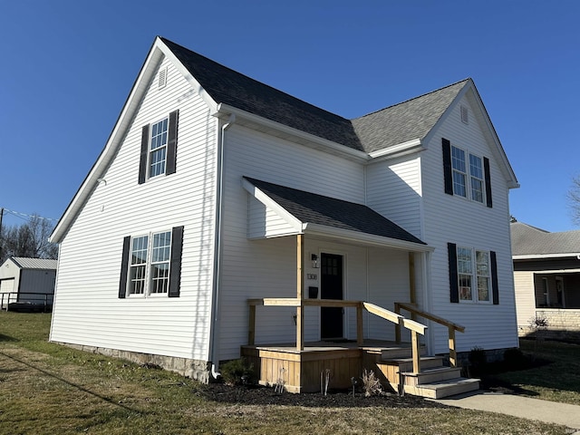 view of front of property with roof with shingles