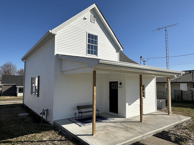 view of front of house with a patio and central air condition unit