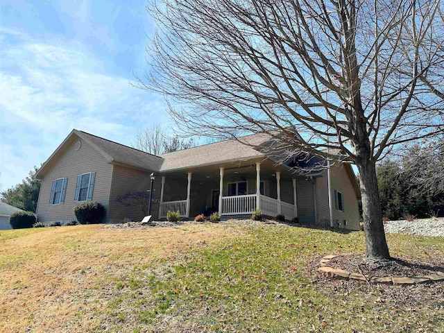 single story home featuring a porch and a front lawn