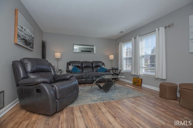 living area featuring wood finished floors and baseboards