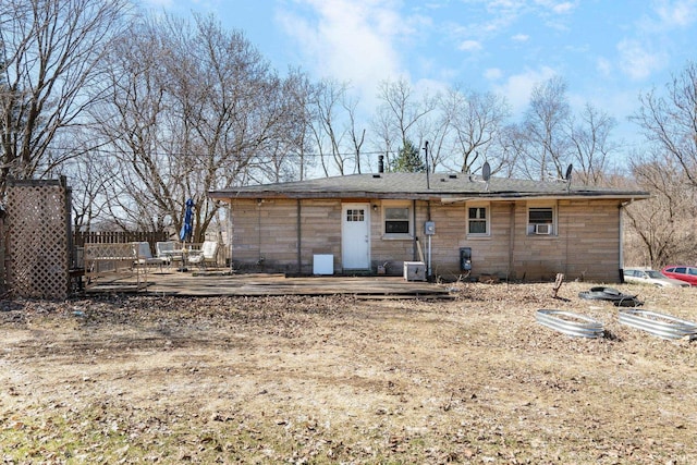 rear view of property with cooling unit