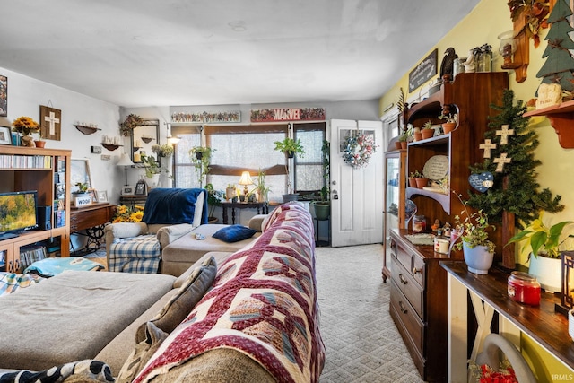 living area featuring light carpet