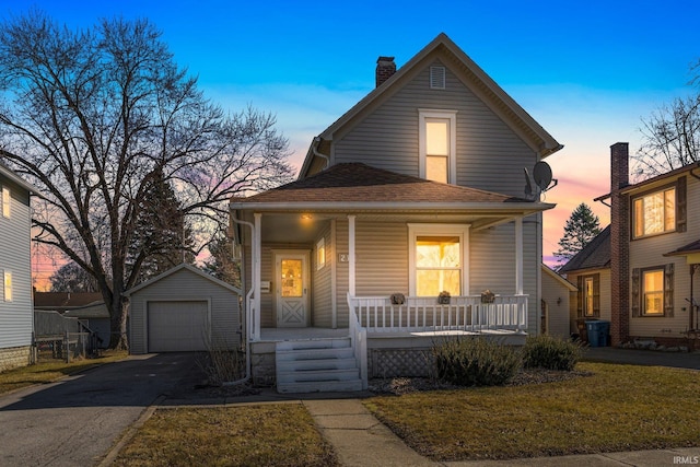 view of front of house featuring a detached garage, roof with shingles, covered porch, an outdoor structure, and driveway