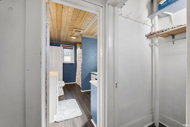 full bath with baseboards, toilet, wooden ceiling, wood finished floors, and vanity