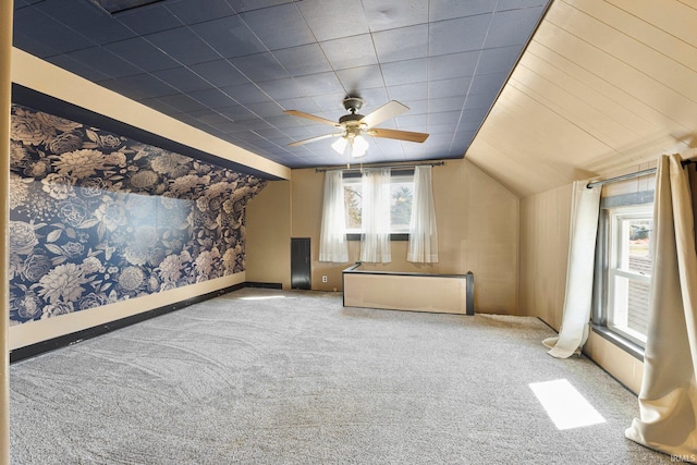 additional living space featuring vaulted ceiling, carpet flooring, and a ceiling fan