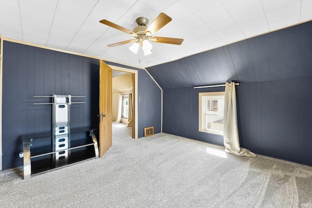 additional living space with vaulted ceiling, carpet floors, and ceiling fan