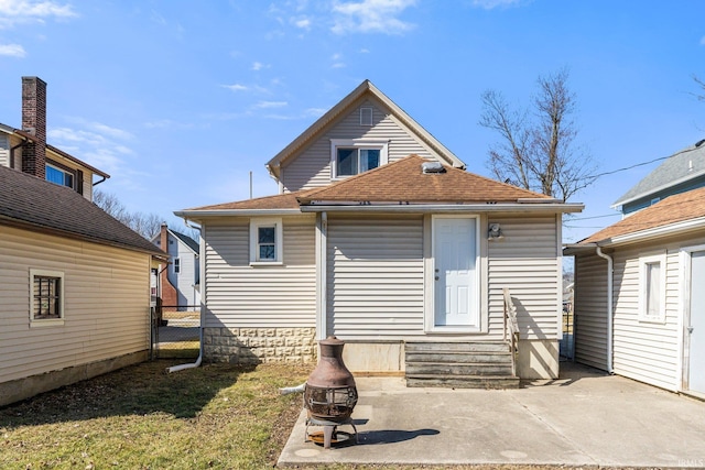 rear view of property with a patio, fence, roof with shingles, and entry steps