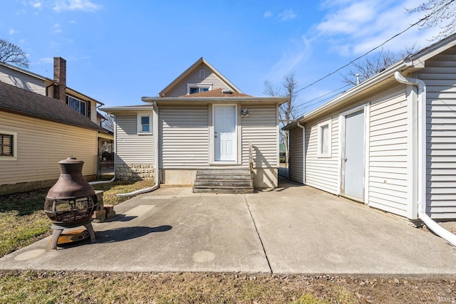 rear view of property featuring a patio and entry steps