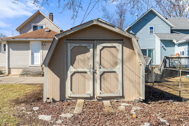 view of shed with entry steps and fence