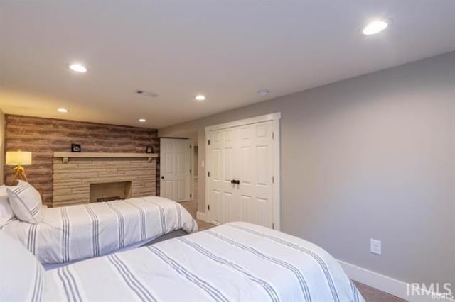 bedroom with recessed lighting, carpet flooring, baseboards, and a fireplace