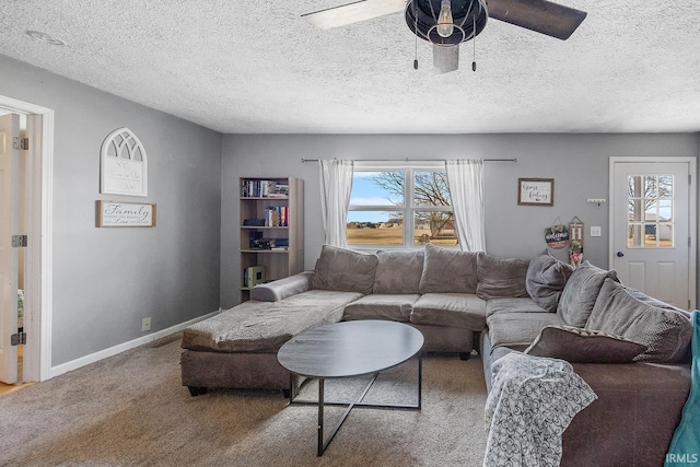 living room with a ceiling fan, carpet, baseboards, and a wealth of natural light