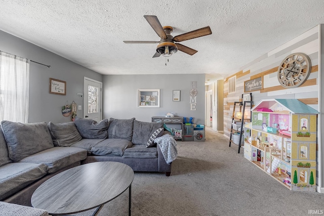 living room with carpet floors, a textured ceiling, and ceiling fan