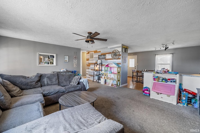 living room featuring carpet flooring, a textured ceiling, and ceiling fan