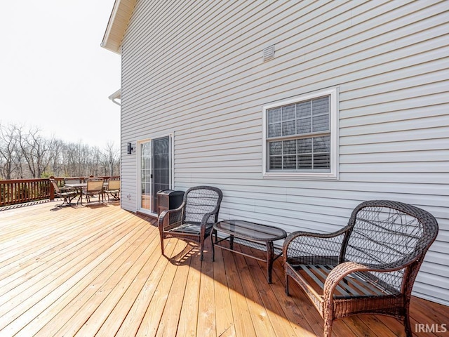 wooden terrace featuring outdoor dining area