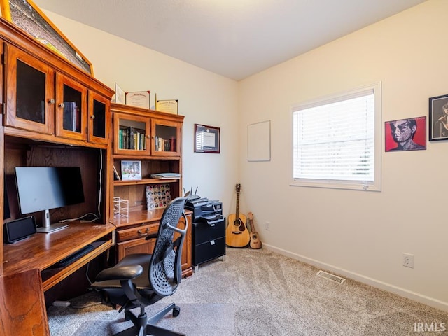 carpeted office with visible vents and baseboards