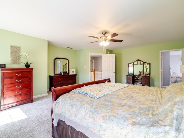 carpeted bedroom with visible vents, baseboards, and ceiling fan