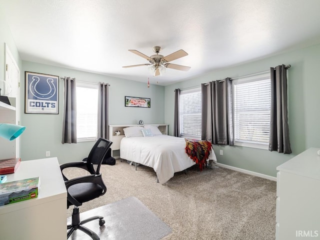 carpeted bedroom featuring baseboards and ceiling fan