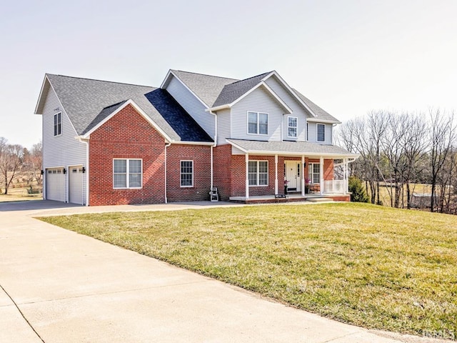 view of front facade with brick siding, a front lawn, covered porch, a garage, and driveway