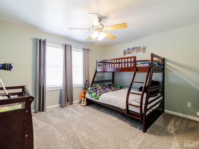 bedroom featuring light carpet, ceiling fan, and baseboards