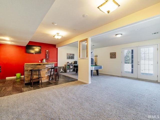 interior space with visible vents, pool table, baseboards, french doors, and a bar