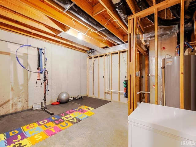 unfinished basement featuring fridge and water heater