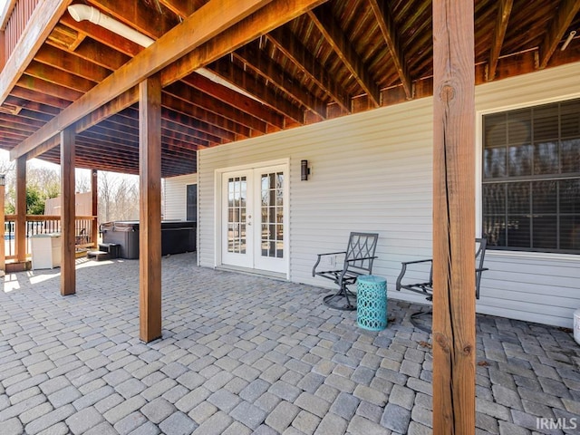 view of patio with french doors and a hot tub