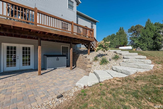 view of yard featuring french doors, a deck, and a patio area